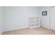 Empty bedroom featuring neutral paint, trim carpet, and a white bookshelf at 2910 E Avenida Olivos --, Phoenix, AZ 85016
