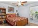 Comfortable bedroom with a queen bed, bookshelf, and a bright window creating a cozy atmosphere at 2910 E Avenida Olivos --, Phoenix, AZ 85016