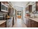 Well-lit kitchen featuring stainless steel appliances, wooden cabinets, and easy access to the outdoor patio at 2910 E Avenida Olivos --, Phoenix, AZ 85016