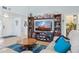 Cozy living room featuring a large entertainment center, plush seating, and a stylish round coffee table at 2910 E Avenida Olivos --, Phoenix, AZ 85016
