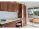 Bright office space with built-in desk, cabinets, and a sliding door to the patio at 2910 E Avenida Olivos --, Phoenix, AZ 85016