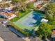 Aerial view of a community tennis court surrounded by grass and landscaping at 2910 E Avenida Olivos --, Phoenix, AZ 85016