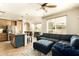 Inviting living room flows to kitchen; featuring comfortable sectional, island seating, and lots of natural light at 2918 N 48Th Pl, Phoenix, AZ 85018