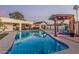 A large outdoor swimming pool and entertaining area with patio, outdoor kitchen, and bar at 3016 N 49Th St, Phoenix, AZ 85018