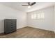 Simple bedroom with a dresser, plantation shutters, wood floors, and neutral tones at 3016 N 49Th St, Phoenix, AZ 85018