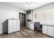 Well-organized closet with built-in shelving and drawers, paired with a functional desk and shuttered windows at 3016 N 49Th St, Phoenix, AZ 85018