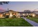 Inviting front exterior with lush lawn, brick accents, and evening glow at 3016 N 49Th St, Phoenix, AZ 85018