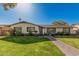 Charming single-story home features a well-manicured lawn and inviting brick pathway at 3016 N 49Th St, Phoenix, AZ 85018