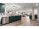 Modern kitchen with green cabinets, stainless steel appliances, quartz countertops, and an open view to the living area at 3016 N 49Th St, Phoenix, AZ 85018