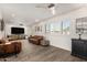 Spacious living room with wood floors, recessed lighting, and bright, shuttered windows at 3016 N 49Th St, Phoenix, AZ 85018