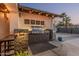 Outdoor kitchen featuring a built-in grill, prep area, and stylish overhead lighting at 3016 N 49Th St, Phoenix, AZ 85018