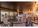 Inviting covered patio featuring comfortable seating, a mounted TV, and ambient string lights for outdoor enjoyment at 3016 N 49Th St, Phoenix, AZ 85018
