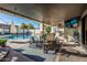 Covered patio with comfortable seating, a ceiling fan, a TV, and access to the backyard pool at 3016 N 49Th St, Phoenix, AZ 85018