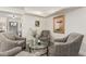 Cozy sitting area with comfortable armchairs, a glass table, and neutral decor at 3016 N 49Th St, Phoenix, AZ 85018
