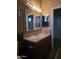 Bathroom featuring a single sink vanity with granite countertops and framed mirrors at 35317 N 31St Dr, Phoenix, AZ 85086