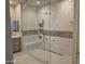 Bathroom featuring double sinks and a glass-enclosed shower with tile surround at 35317 N 31St Dr, Phoenix, AZ 85086
