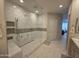 Bathroom featuring double sinks and a glass-enclosed shower with tile surround at 35317 N 31St Dr, Phoenix, AZ 85086