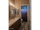 Bathroom featuring a double sink vanity with granite countertops and framed mirrors at 35317 N 31St Dr, Phoenix, AZ 85086