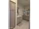 Bathroom boasts a long vanity with double mirrors and plentiful cabinet storage, and sleek tile floors at 35317 N 31St Dr, Phoenix, AZ 85086