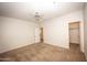 Neutral bedroom featuring plush carpet, ceiling fan, and door leading to the walk-in closet at 35317 N 31St Dr, Phoenix, AZ 85086