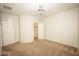 Cozy bedroom featuring neutral carpet, a ceiling fan, and a closet, perfect for a relaxing retreat at 35317 N 31St Dr, Phoenix, AZ 85086
