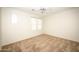Neutral bedroom featuring plush carpet, ceiling fan, and natural light from the window at 35317 N 31St Dr, Phoenix, AZ 85086