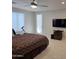 Bright bedroom featuring a TV, a door to the outside, and tile flooring at 35317 N 31St Dr, Phoenix, AZ 85086