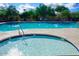 A view of the refreshing community spa with clear water surrounded by desert landscaping and blue skies at 35317 N 31St Dr, Phoenix, AZ 85086