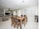 Dining room with wooden table set and an open view to the living room and large windows at 35317 N 31St Dr, Phoenix, AZ 85086