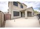 Two-story stucco home with backyard patio and view of gate to side yard at 35317 N 31St Dr, Phoenix, AZ 85086