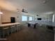 Large game room boasts with a bar area, air hockey table, and stylish ceiling fans at 35317 N 31St Dr, Phoenix, AZ 85086