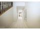 Bright and airy hallway with elegant tile flooring and a staircase with wrought iron railing at 35317 N 31St Dr, Phoenix, AZ 85086