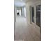 A hallway features pristine white tile floors, double doors and natural light from a window at 35317 N 31St Dr, Phoenix, AZ 85086
