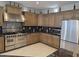 Modern kitchen featuring stainless steel appliances, granite countertops, and ample cabinet space at 35317 N 31St Dr, Phoenix, AZ 85086
