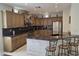 Spacious kitchen with custom cabinets, granite countertops, stainless steel appliances, and breakfast bar at 35317 N 31St Dr, Phoenix, AZ 85086