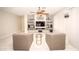 Bright living room with tile floors, stylish fan, and built-in entertainment center with shelving at 35317 N 31St Dr, Phoenix, AZ 85086