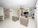 Spacious living room featuring tile flooring, modern fan, and a built-in entertainment center at 35317 N 31St Dr, Phoenix, AZ 85086