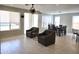 Inviting open floor plan with tile flooring, ceiling fan, and cozy sitting area next to dining table at 35317 N 31St Dr, Phoenix, AZ 85086