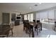 Open-concept living room featuring a built-in entertainment center, dining area, and lots of natural light at 35317 N 31St Dr, Phoenix, AZ 85086
