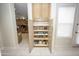Walk-in pantry with pull-out shelving, providing ample storage space for kitchen essentials at 35317 N 31St Dr, Phoenix, AZ 85086