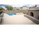 Private backyard oasis featuring a pool, spa, outdoor fireplace, and lush greenery at 35317 N 31St Dr, Phoenix, AZ 85086