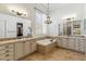 A bright bathroom featuring double sinks, a soaking tub, tile flooring, and a chandelier at 41624 N Anthem Ridge Dr, Anthem, AZ 85086