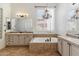 A bright bathroom featuring double sinks, a soaking tub, tile flooring, and a chandelier at 41624 N Anthem Ridge Dr, Anthem, AZ 85086