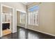 Bedroom with dark hardwood floors and a large window, adjacent to ensuite bath and closet at 41624 N Anthem Ridge Dr, Anthem, AZ 85086