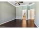 A spacious bedroom featuring dark hardwood floors, ceiling fan, and neutral-colored walls at 41624 N Anthem Ridge Dr, Anthem, AZ 85086