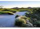 Scenic view of the golf course with lush green fairways, sand traps, and mountain backdrop at 41624 N Anthem Ridge Dr, Anthem, AZ 85086