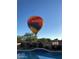 Hot air balloon over the pool and backyard, showing the beautiful community at 41624 N Anthem Ridge Dr, Anthem, AZ 85086