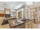 Open concept kitchen view, with granite island and living room fireplace in the background at 41624 N Anthem Ridge Dr, Anthem, AZ 85086
