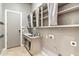 Functional laundry room features upper cabinet storage, a sink, and neutral colors at 41624 N Anthem Ridge Dr, Anthem, AZ 85086