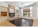 Bright living room with a stone fireplace, custom built-ins, and large windows offering natural light at 41624 N Anthem Ridge Dr, Anthem, AZ 85086